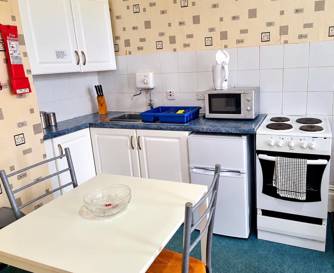Apartment kitchen and dining table at Beeton Villas