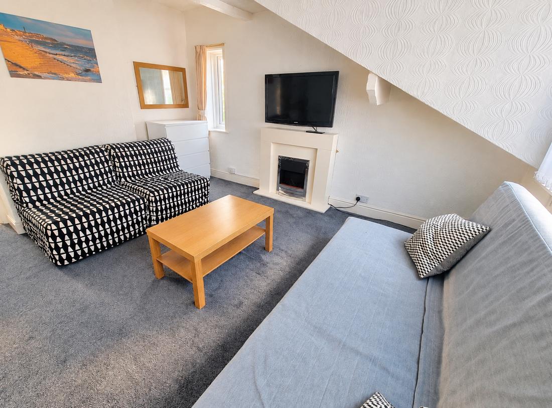 Apartment lounge with sofas and TV